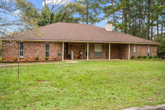 a view of a house with yard and tree s
