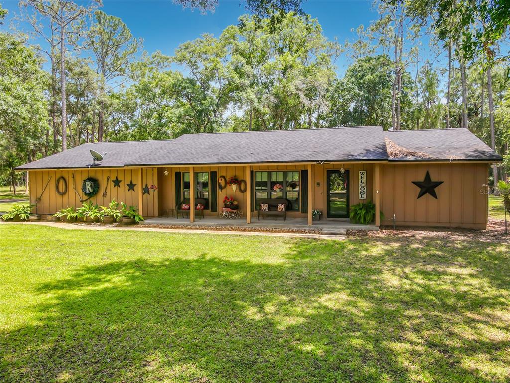 1395 Maytown Road Osteen, FL 32764 - Photo 5 of 65 a front view of a house with garden