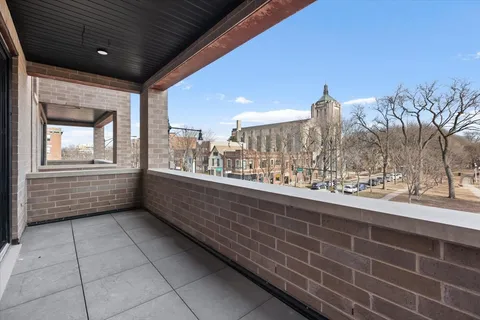 a view of a terrace with furniture and city view