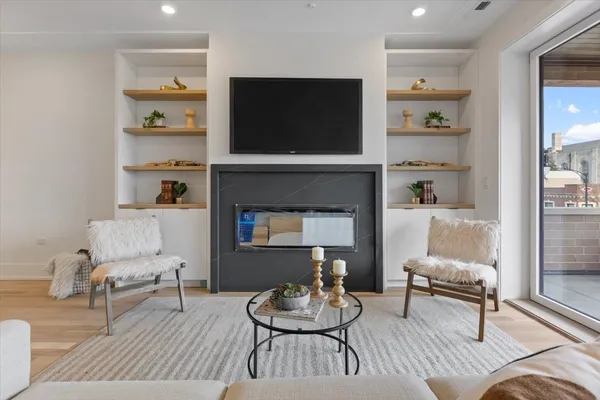 a living room with furniture and a potted plant