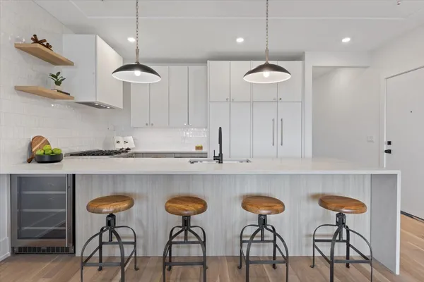 a kitchen with stainless steel appliances granite countertop a sink and dishwasher a refrigerator with wooden cabinets