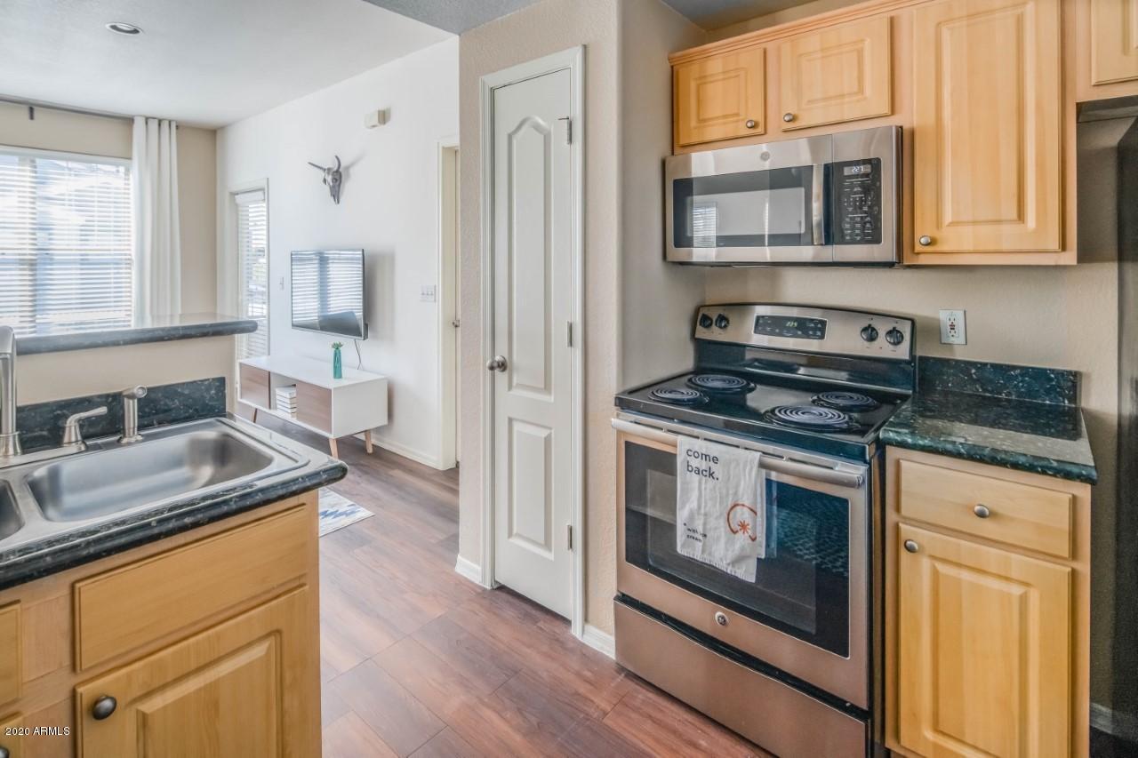 10 West Minnezona Avenue, Unit 2 Phoenix, AZ 85012 - Photo 3 of 9 a kitchen with stainless steel appliances granite countertop a stove a sink and a microwave