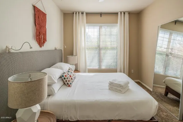 a bedroom with a bed and a window