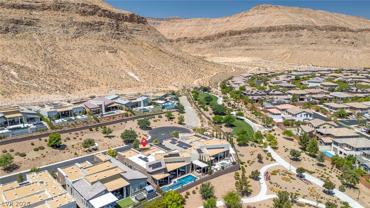 6014 Willow Ridge Court Las Vegas, NV 89135 - Photo 88 of 99 An aerial perspective reveals a vibrant neighborhood nestled against rugged desert mountains.