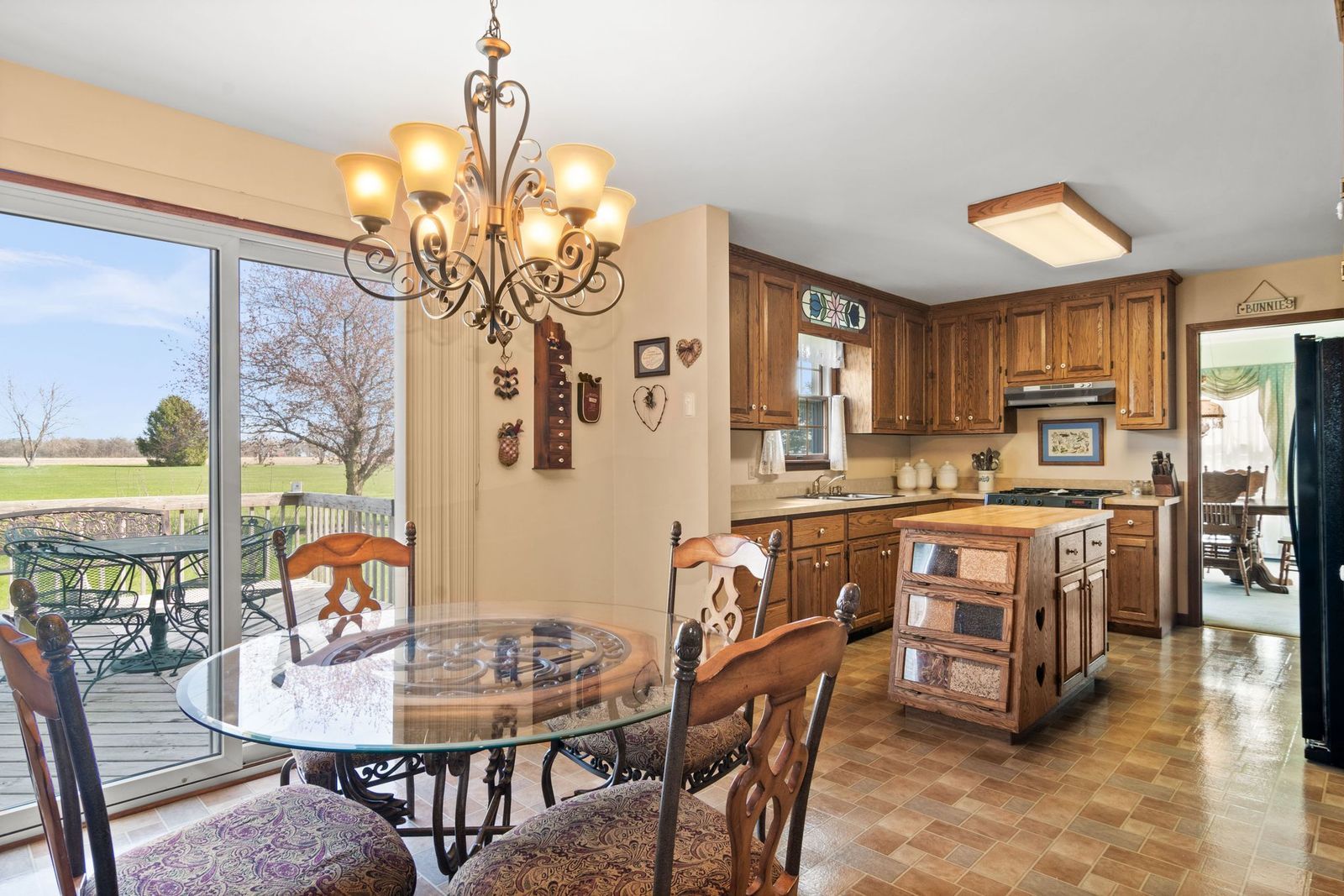 16247 Pratt Road Sandwich, IL 60548 - Photo 12 of 47 a kitchen with stainless steel appliances granite countertop a stove a kitchen island a dining table and chairs
