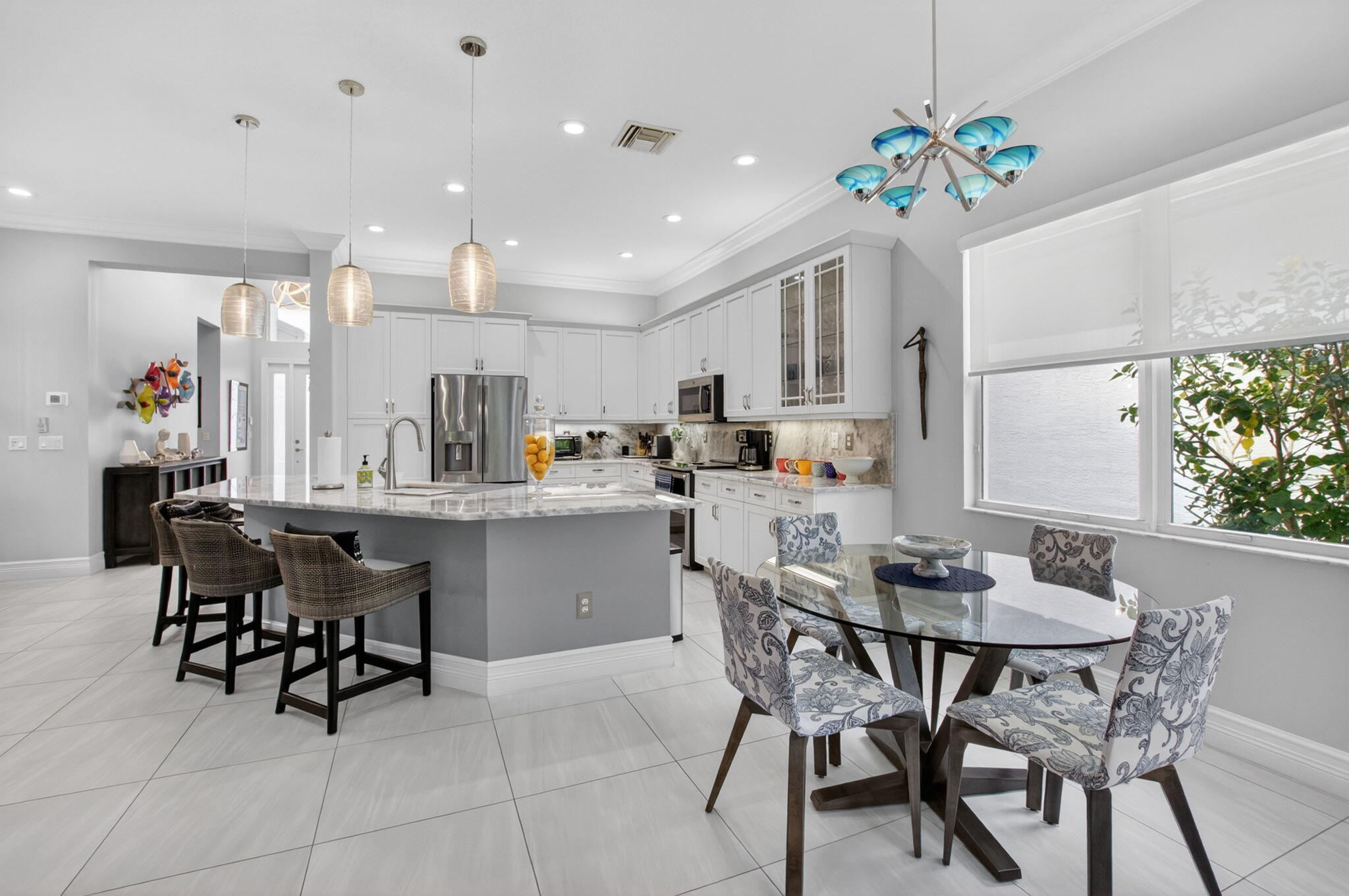 8263 Arabian Range Road Boynton Beach, FL 33473 - Photo 17 of 52 a kitchen with a dining table chairs and refrigerator