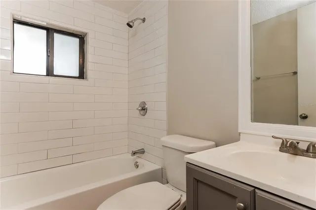 a bathroom with a sink toilet vanity and shower
