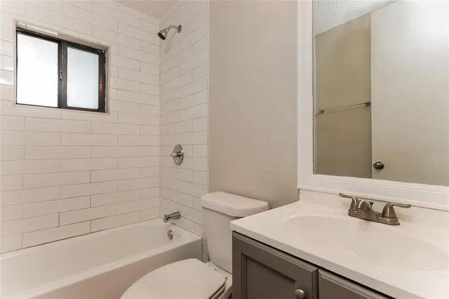 a bathroom with a sink toilet vanity and bathtub