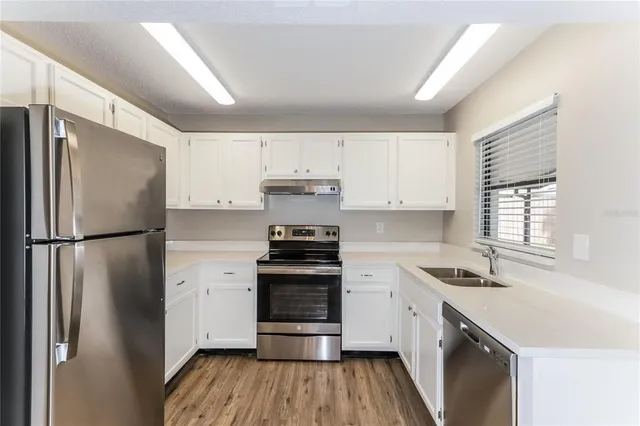 a kitchen with a refrigerator sink and stove