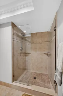 a bedroom with a bed a mirror and lamp on desk