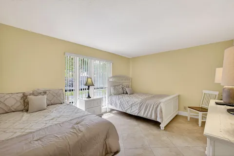 a view of a balcony with chair and floor to ceiling window