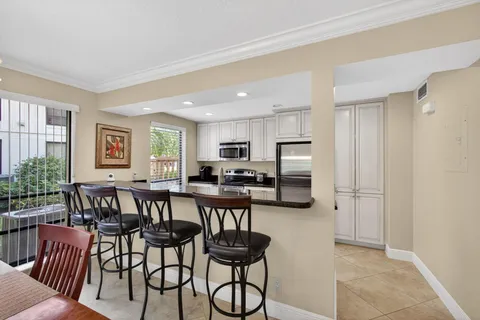 a view of a dining room with furniture wooden floor and chandelier