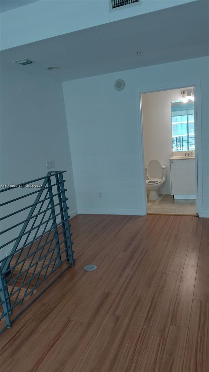 60 Southwest 13th Street, Unit 2612 Miami, FL 33130 - Photo 2 of 5 a view of wooden floor and windows in a room