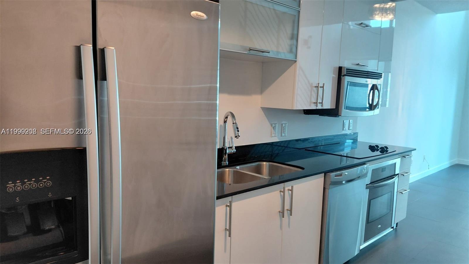 60 Southwest 13th Street, Unit 2612 Miami, FL 33130 - Photo 5 of 5 a kitchen with a sink and a refrigerator