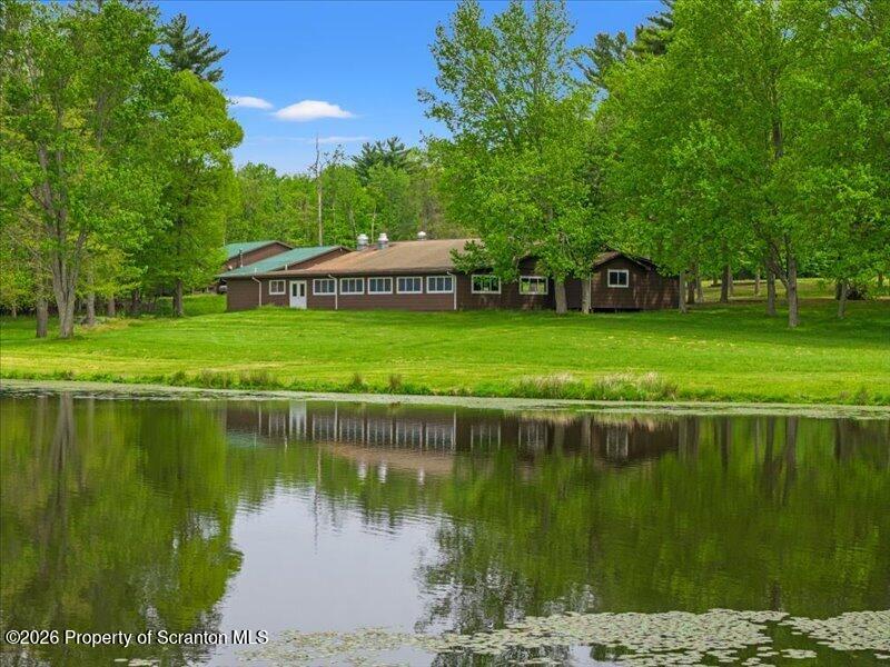 9-17 Vago Road Tunkhannock, PA 18657 - Photo 31 of 57 a view of a lake with a house in the background