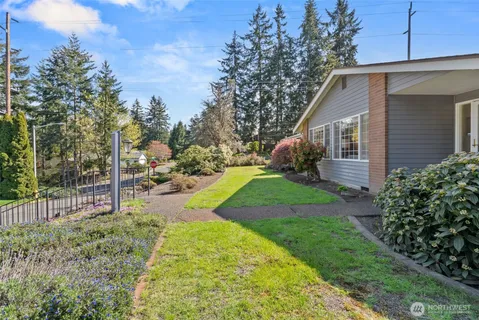 a view of a house with backyard and sitting area