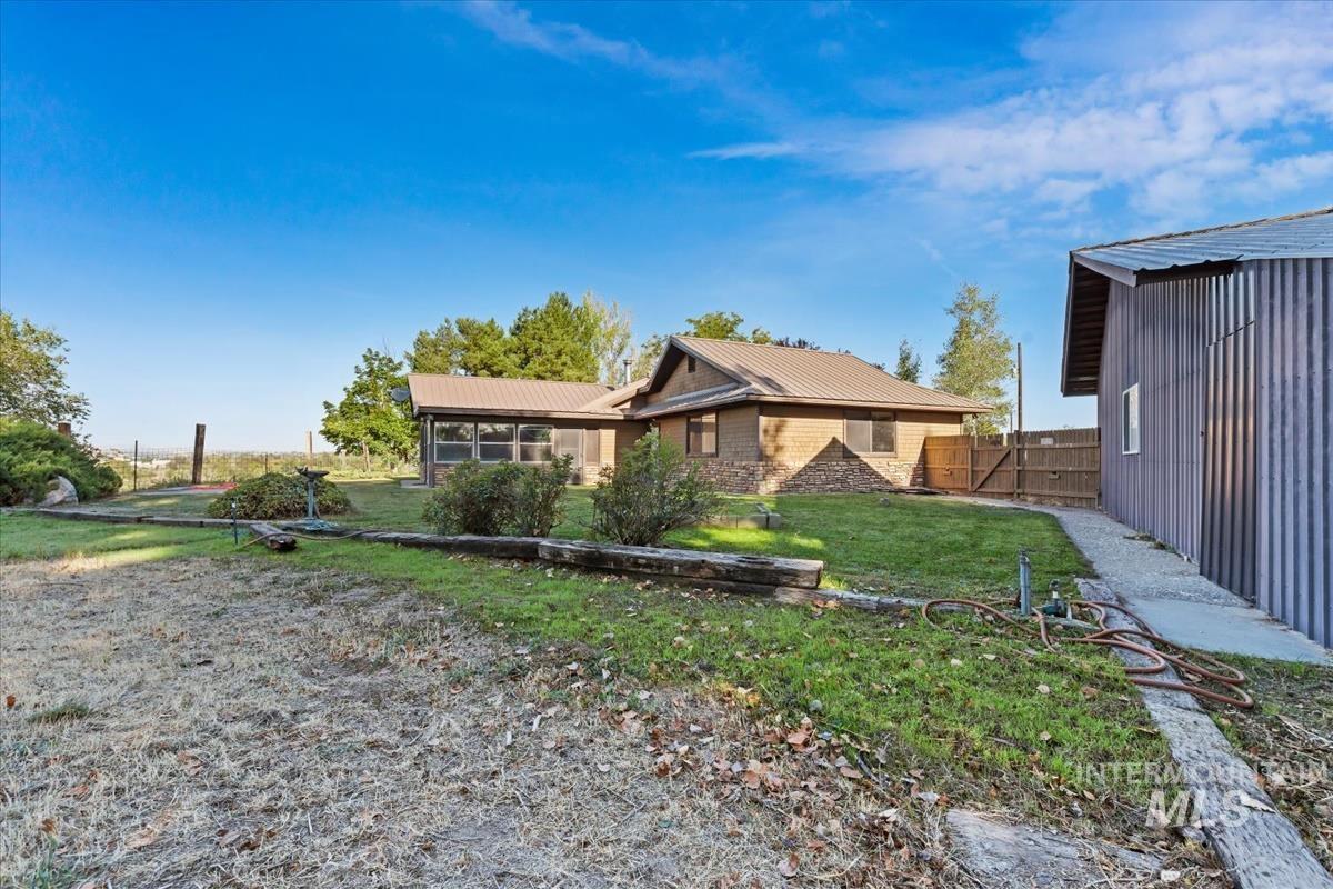 8275 Washoe Road Fruitland, ID 83619 - Photo 30 of 43 Corrugated metal siding structure, metal roof, and wood fencing