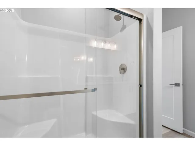 a bathroom with a shower and a glass door