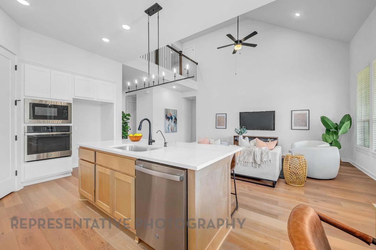 22223 Mount Whitney Road Waller, TX 77484 - Photo 3 of 19 a kitchen view with microwave a stove and white cabinets