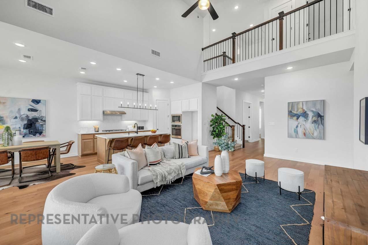 22223 Mount Whitney Road Waller, TX 77484 - Photo 6 of 19 a living room with furniture kitchen view and a chandelier