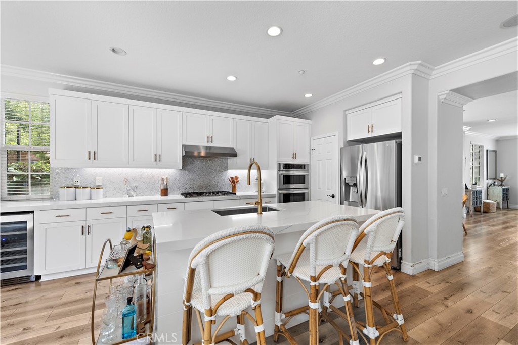 8 Bluewing Lane Ladera Ranch, CA 92694 - Photo 18 of 55 a kitchen with stainless steel appliances granite countertop a stove top oven a sink refrigerator and white cabinets