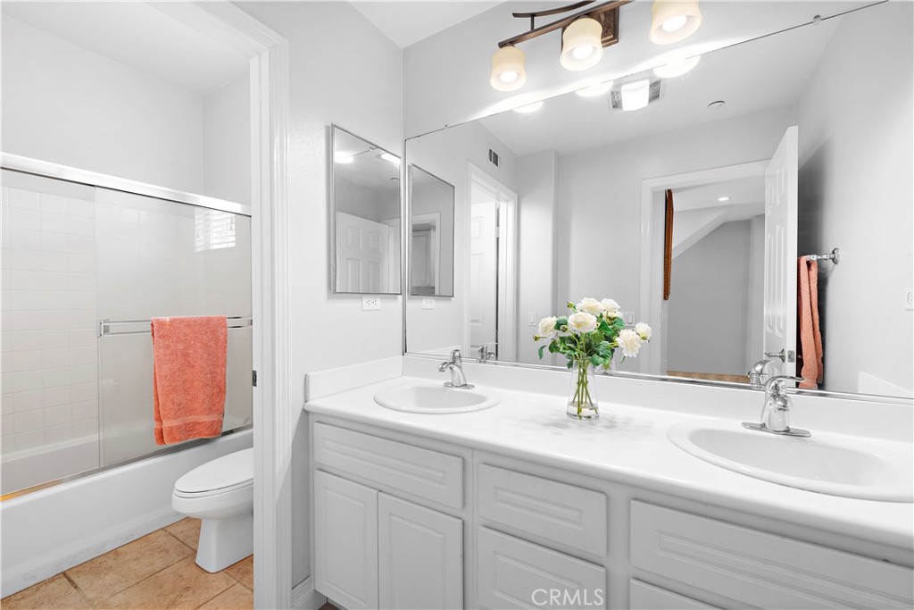 8 Bluewing Lane Ladera Ranch, CA 92694 - Photo 35 of 55 a bathroom with a sink a toilet and a large mirror