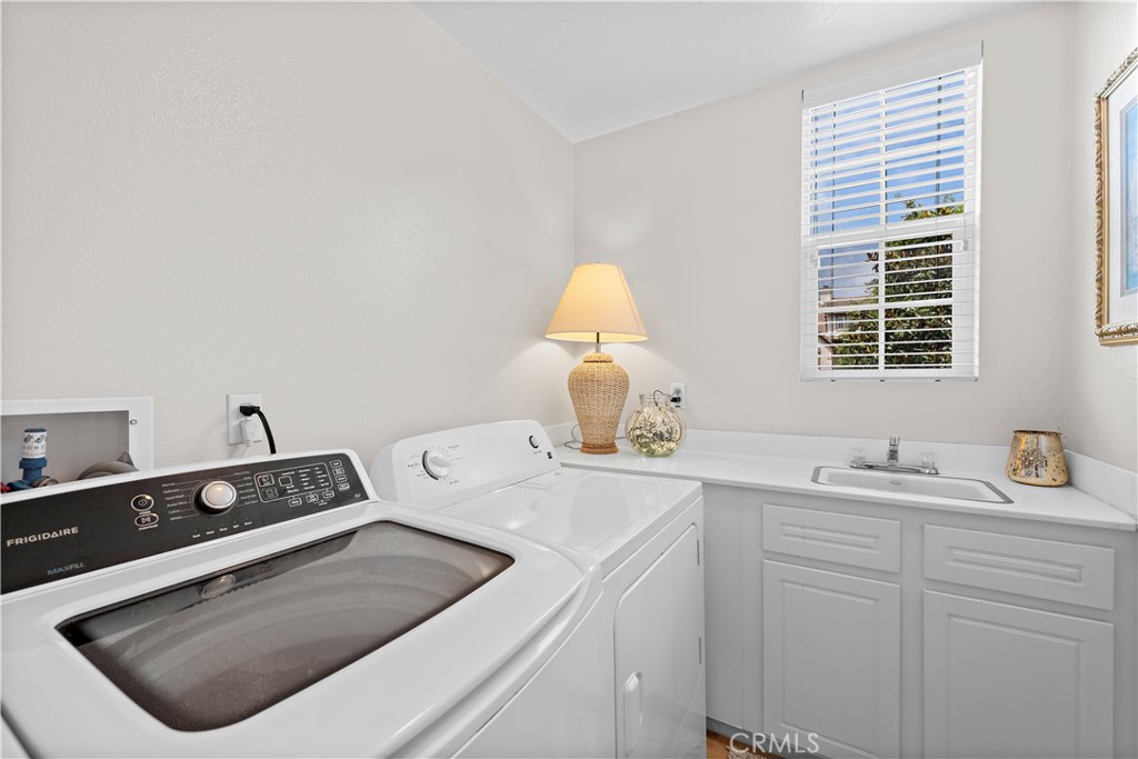 8 Bluewing Lane Ladera Ranch, CA 92694 - Photo 37 of 55 a utility room with sink dryer and washer