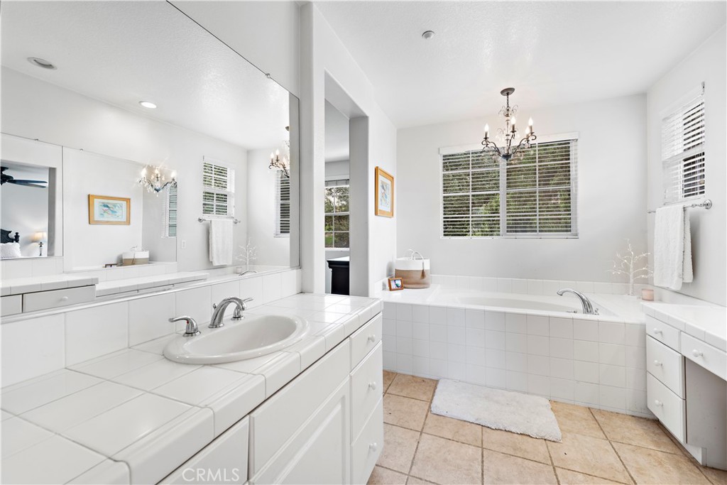8 Bluewing Lane Ladera Ranch, CA 92694 - Photo 44 of 55 a bathroom with a tub sink and mirror