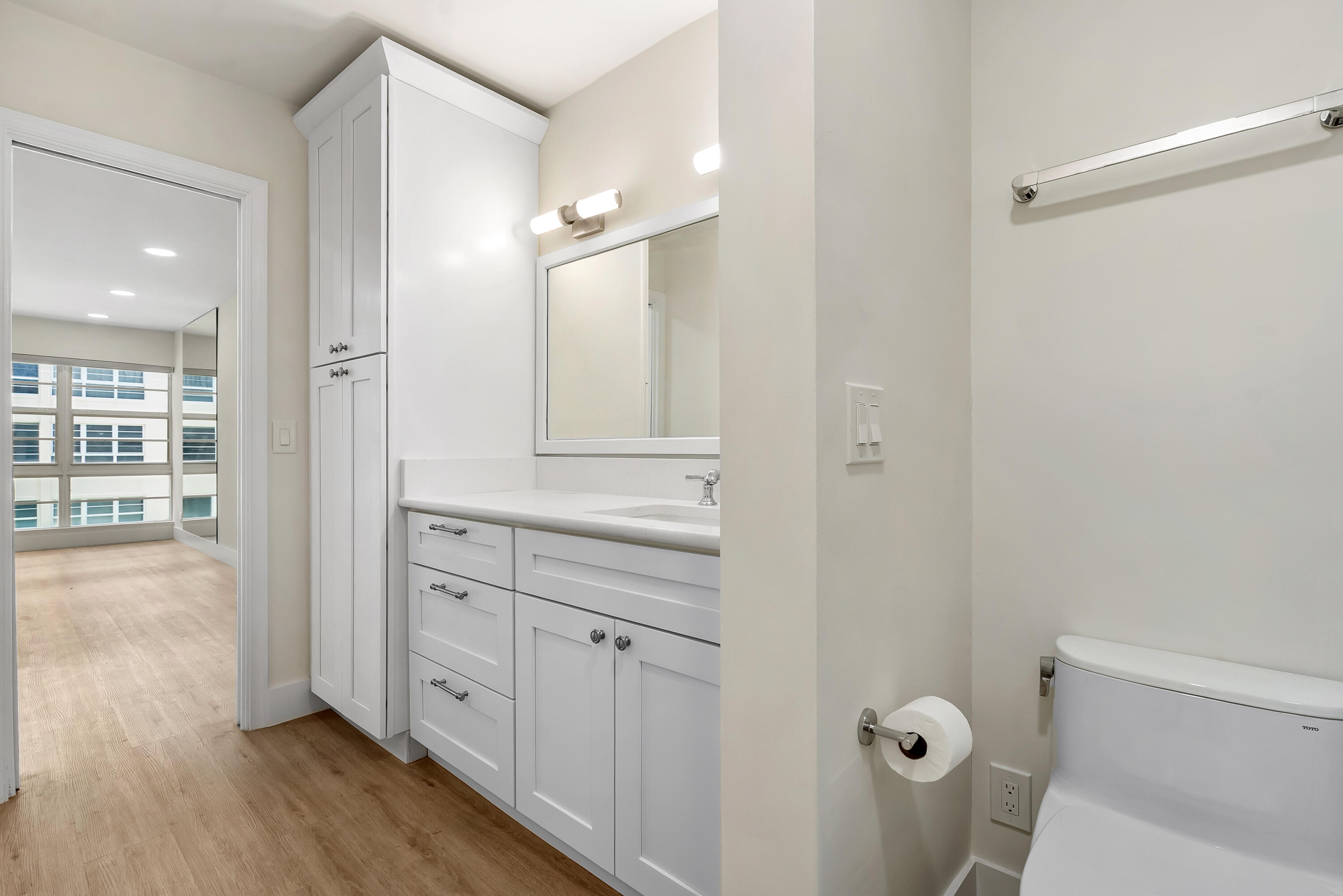 3851 North Ocean Boulevard, Unit 211 Gulf Stream, FL 33483 - Photo 13 of 19 a bathroom with a sink and mirror with toilet