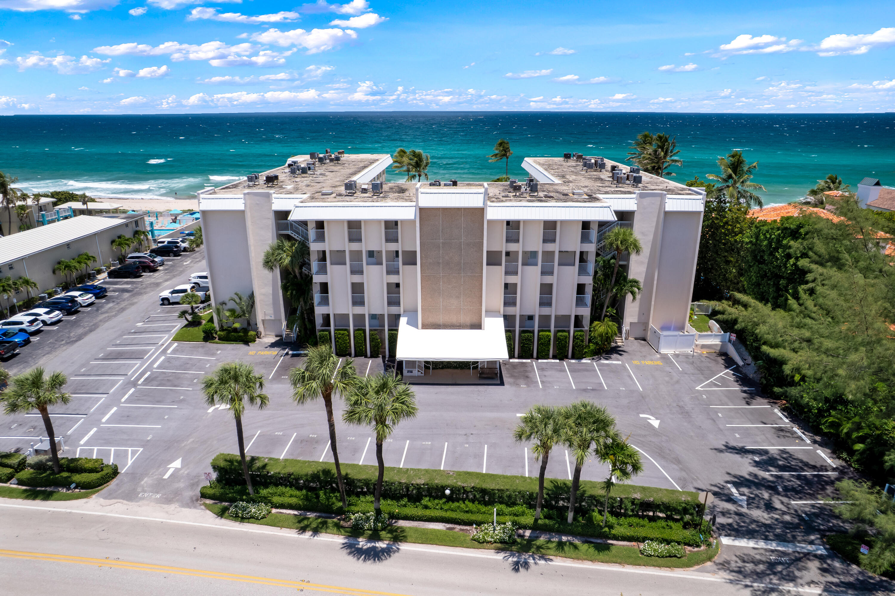 3851 North Ocean Boulevard, Unit 211 Gulf Stream, FL 33483 - Photo 14 of 19 a front view of a house with a yard
