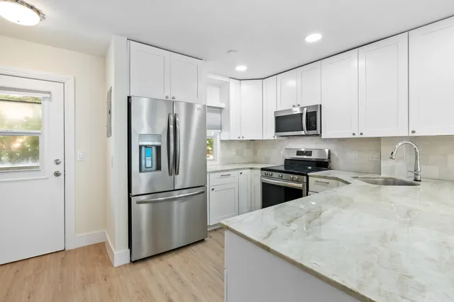 a kitchen with a refrigerator stove and microwave