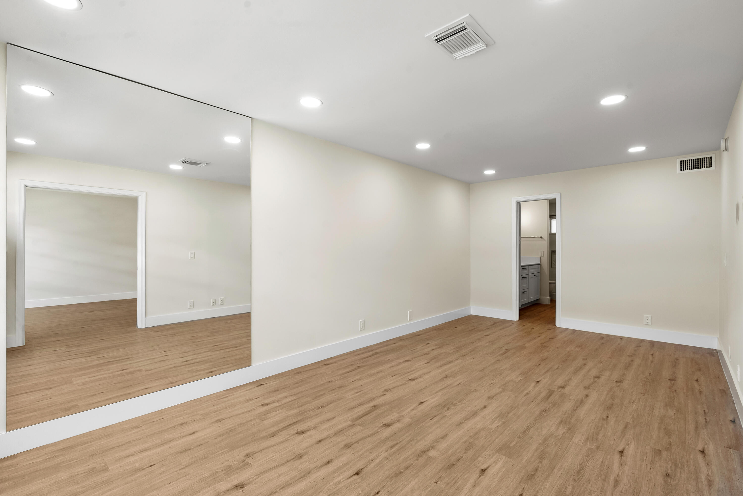 3851 North Ocean Boulevard, Unit 211 Gulf Stream, FL 33483 - Photo 9 of 19 a view of an empty room with wooden floor