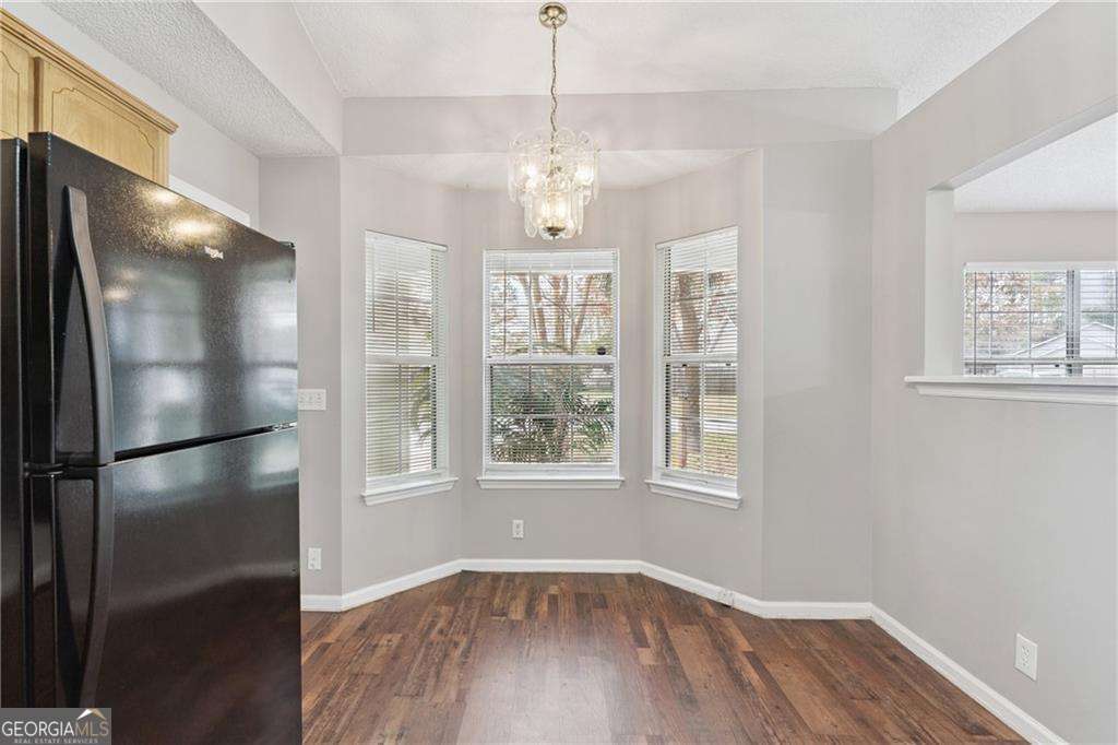 336 Terrapin Trail Brunswick, GA 31525 - Photo 11 of 24 a view of an empty room with wooden floor and a window