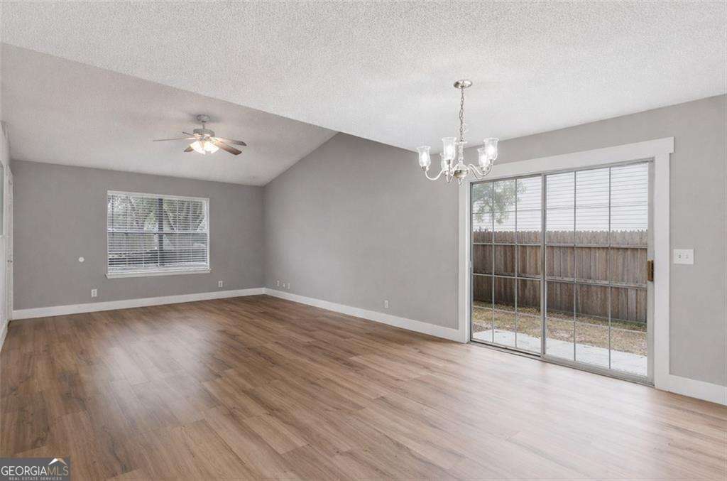 336 Terrapin Trail Brunswick, GA 31525 - Photo 13 of 24 a view of an empty room with wooden floor and a window