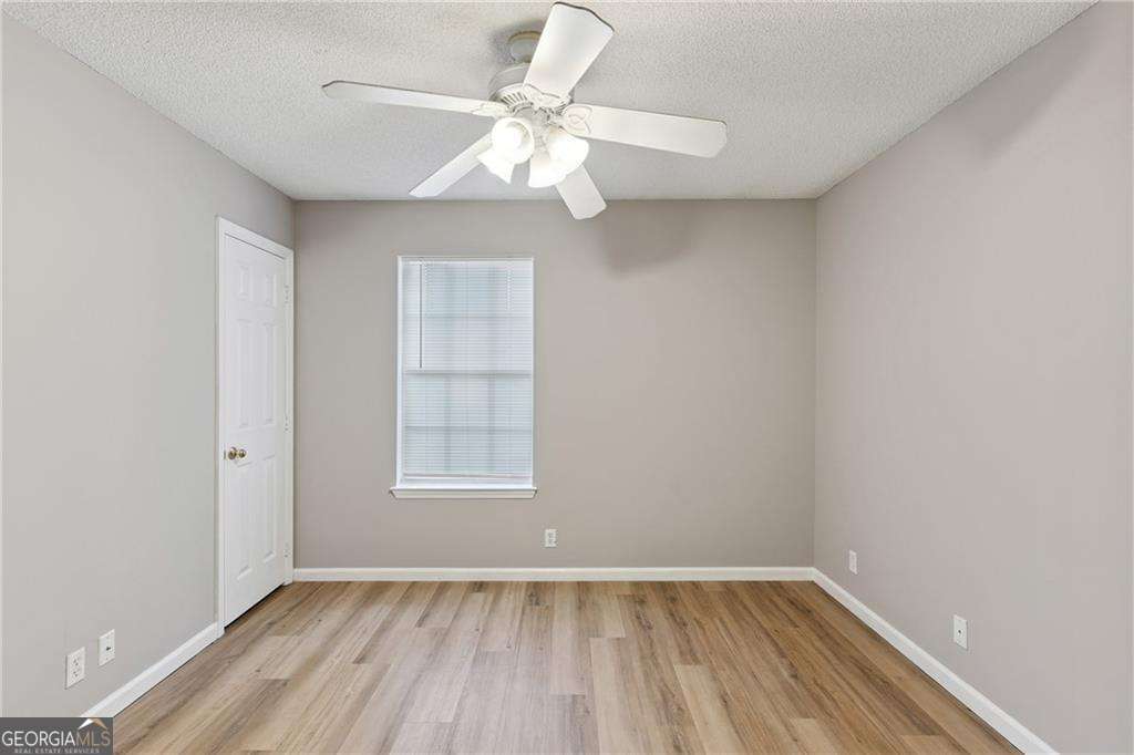 336 Terrapin Trail Brunswick, GA 31525 - Photo 16 of 24 wooden floor in an empty room with a window