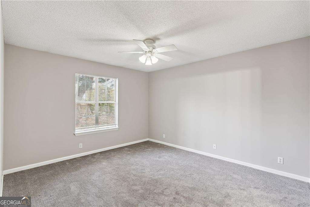 336 Terrapin Trail Brunswick, GA 31525 - Photo 17 of 24 an empty room with a window and a fan