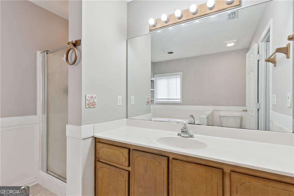 336 Terrapin Trail Brunswick, GA 31525 - Photo 18 of 24 a bathroom with a sink vanity and mirror