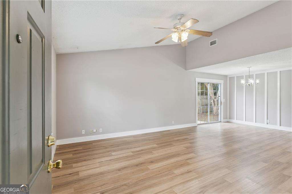336 Terrapin Trail Brunswick, GA 31525 - Photo 4 of 24 a view of an empty room with wooden floor and a ceiling fan