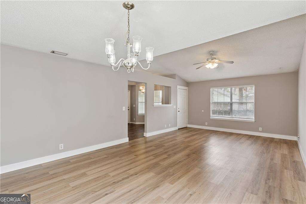 336 Terrapin Trail Brunswick, GA 31525 - Photo 6 of 24 a view of an empty room with wooden floor and a window