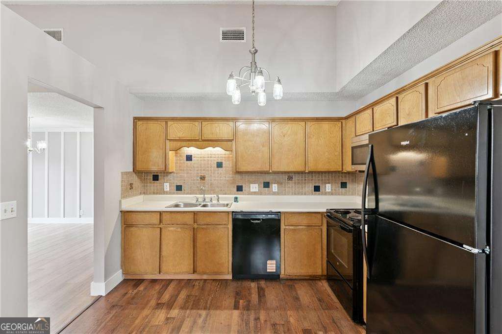 336 Terrapin Trail Brunswick, GA 31525 - Photo 7 of 24 a kitchen with a sink stainless steel appliances cabinets and a window
