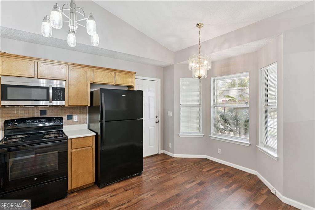 336 Terrapin Trail Brunswick, GA 31525 - Photo 10 of 24 a kitchen with granite countertop a refrigerator and a stove top oven