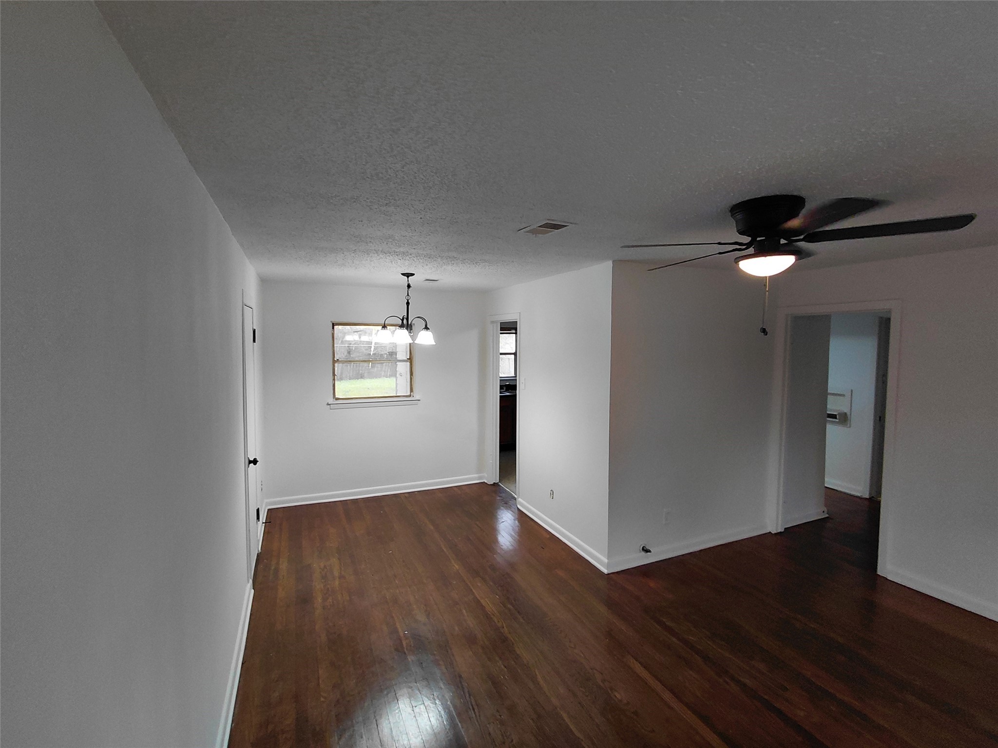 201 Delta Street Pasadena, TX 77506 - Photo 13 of 19 an empty room with wooden floor and windows