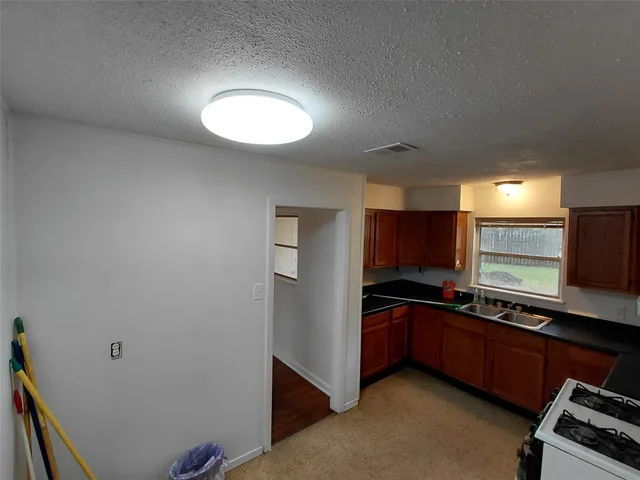 a kitchen with stainless steel appliances a sink and a stove