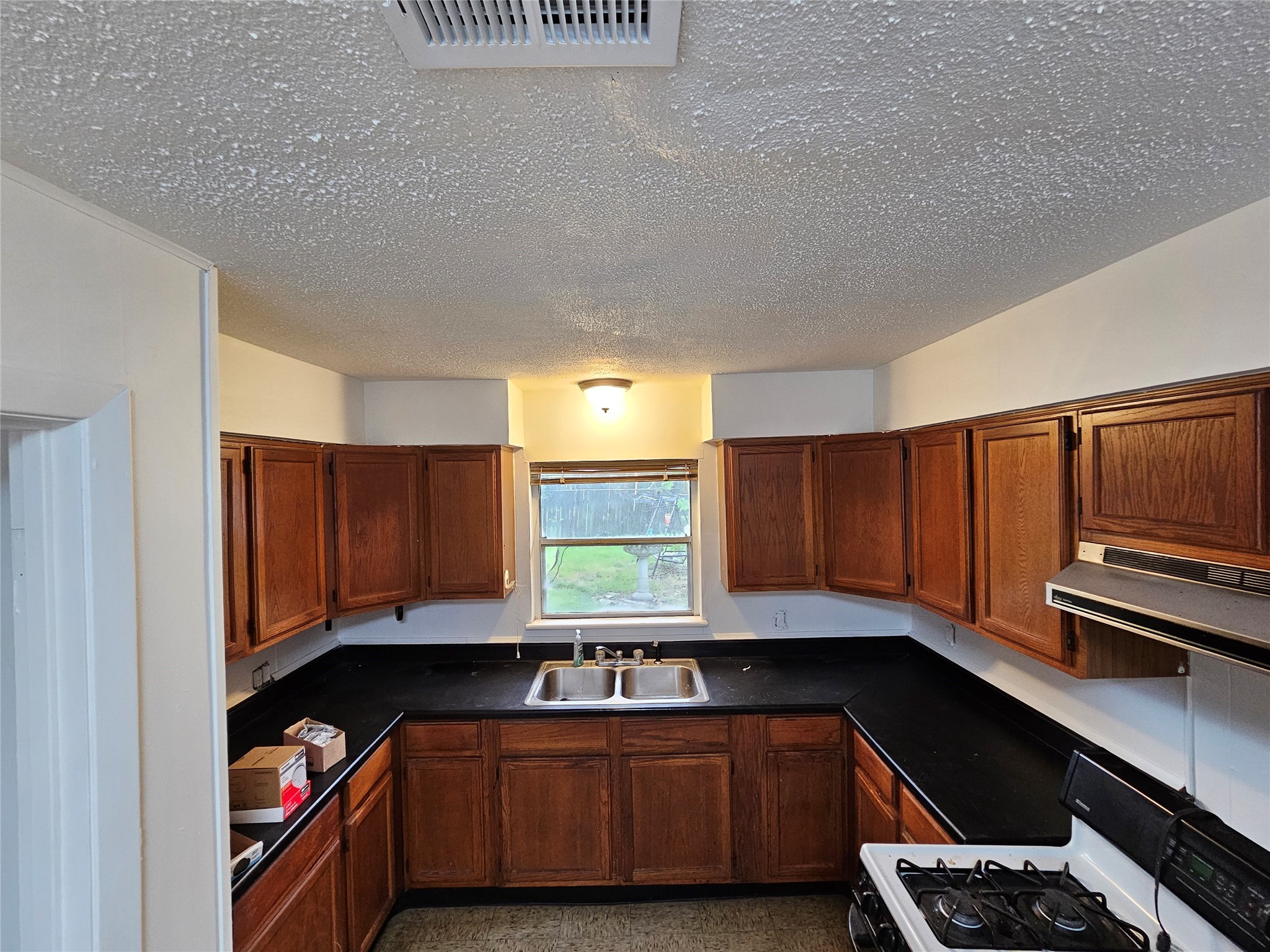 201 Delta Street Pasadena, TX 77506 - Photo 5 of 19 a kitchen with a sink cabinets and window