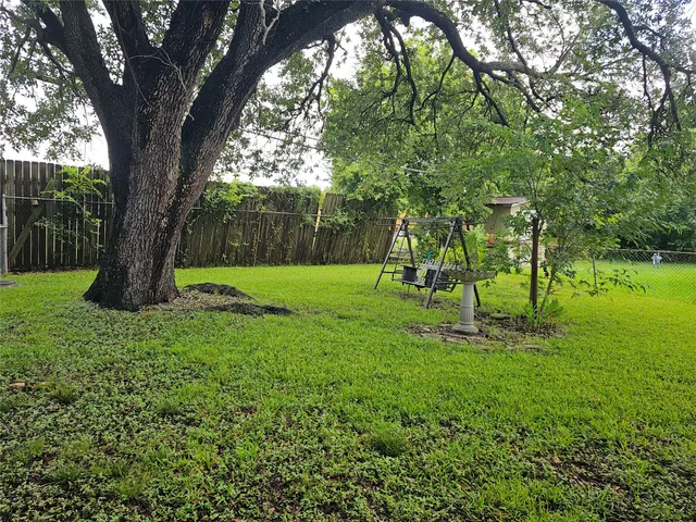 a view of a backyard with a tree