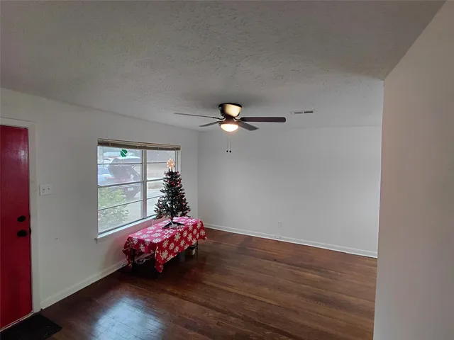 a room with wooden floor and window