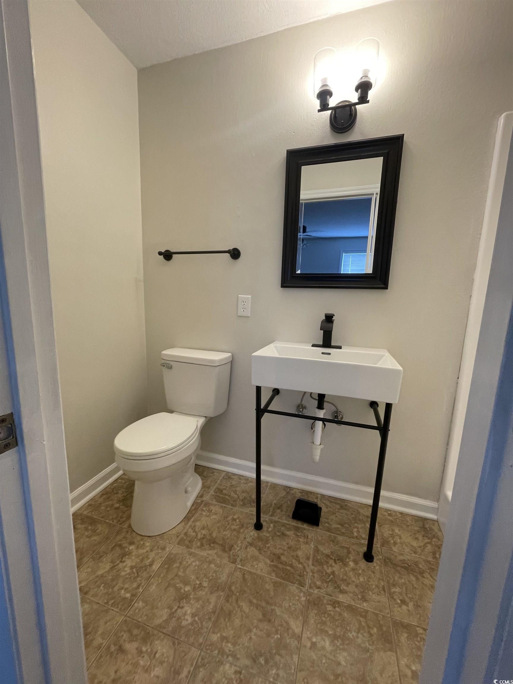 4641 Socastee Boulevard, Unit E1 Myrtle Beach, SC 29588 - Photo 12 of 20 Half bath featuring light tile patterned floors
