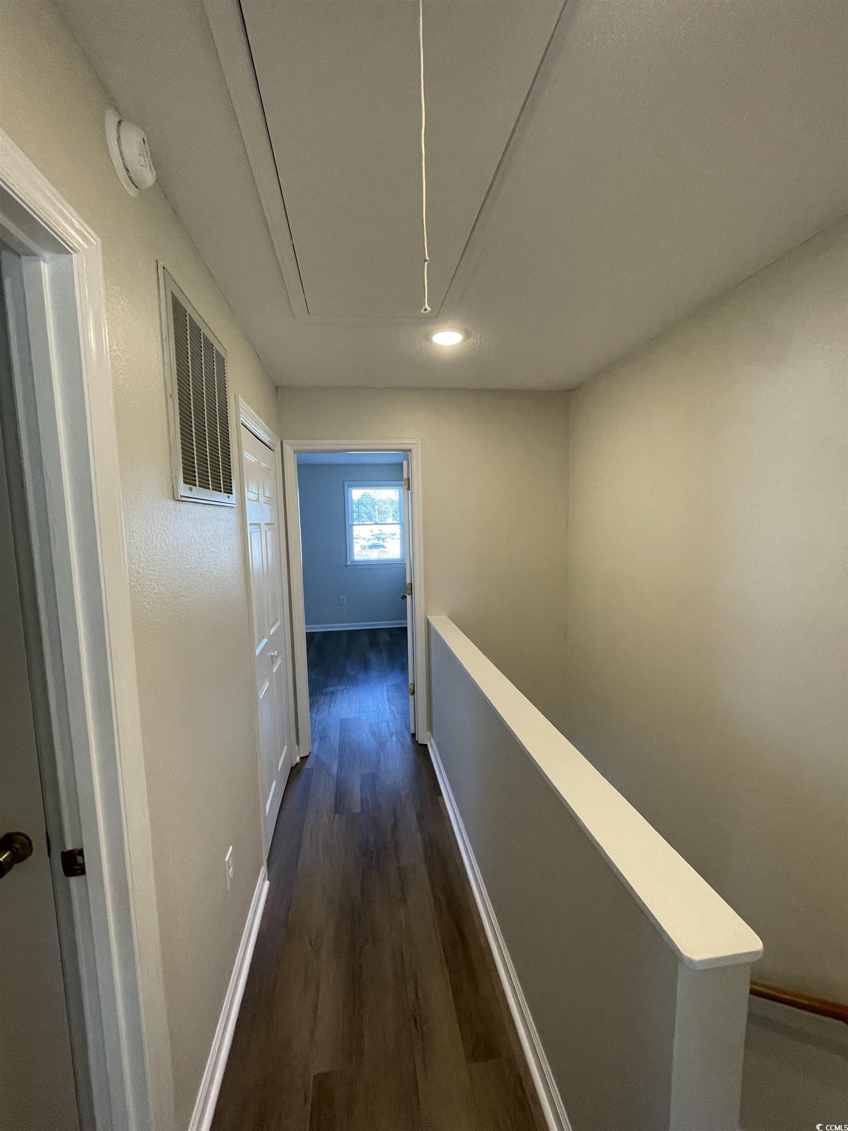 4641 Socastee Boulevard, Unit E1 Myrtle Beach, SC 29588 - Photo 15 of 20 Hallway with attic access, dark wood finished floors, and recessed lighting