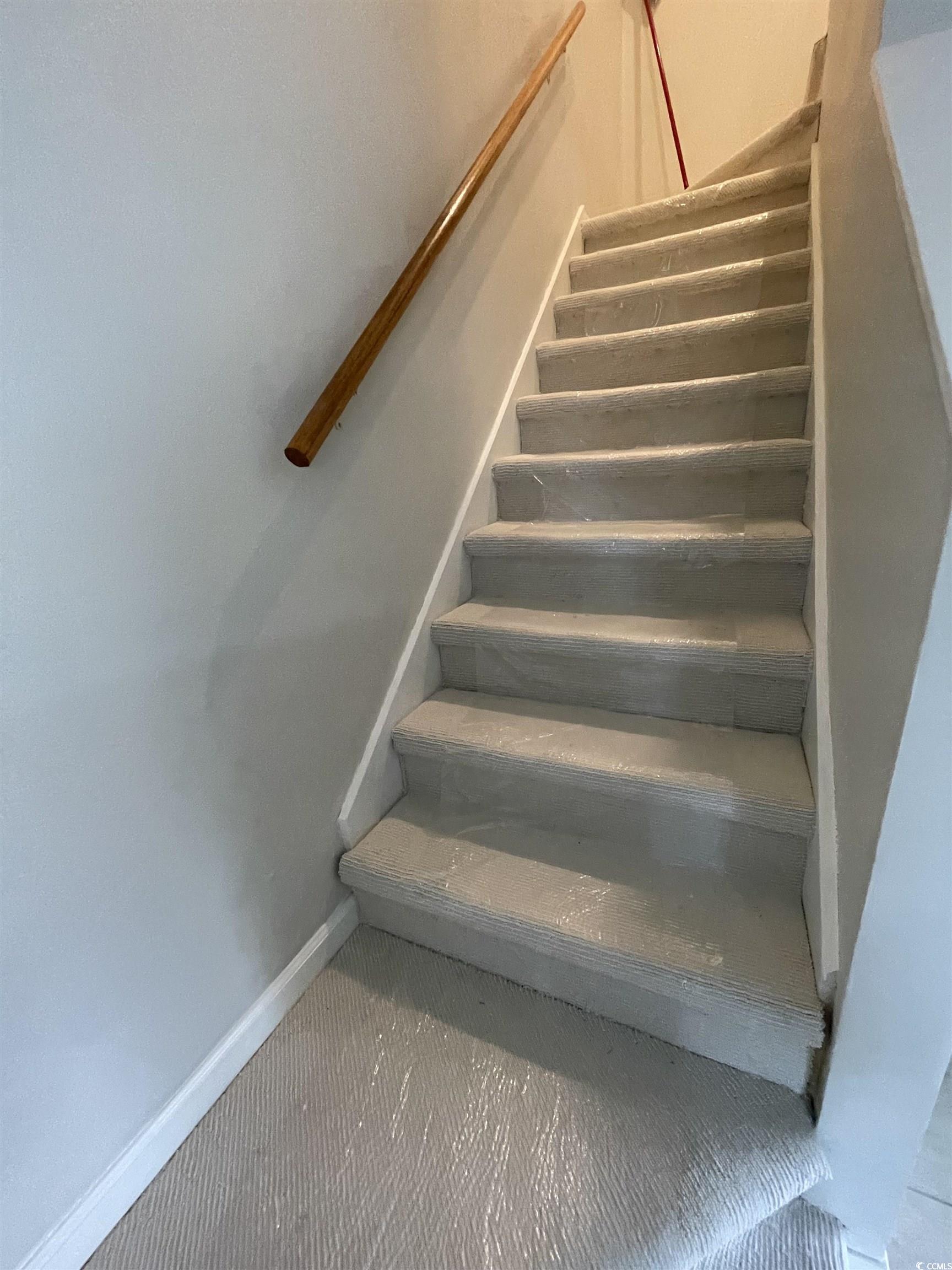 4641 Socastee Boulevard, Unit E1 Myrtle Beach, SC 29588 - Photo 16 of 20 Stairs with baseboards