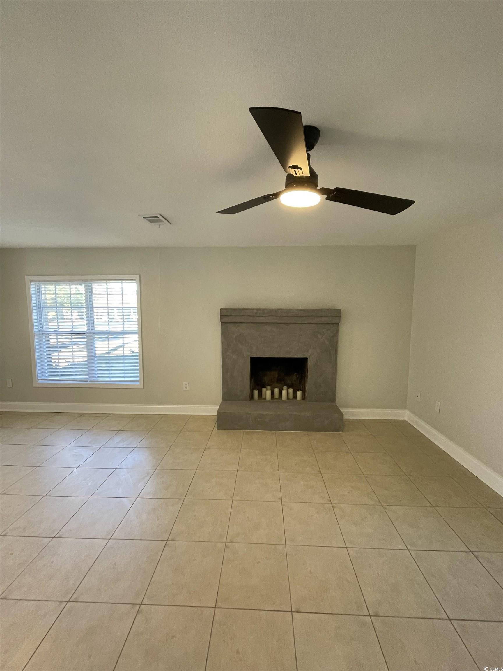 4641 Socastee Boulevard, Unit E1 Myrtle Beach, SC 29588 - Photo 18 of 20 Unfurnished living room featuring light tile patterned floors, a high end fireplace, and a ceiling fan
